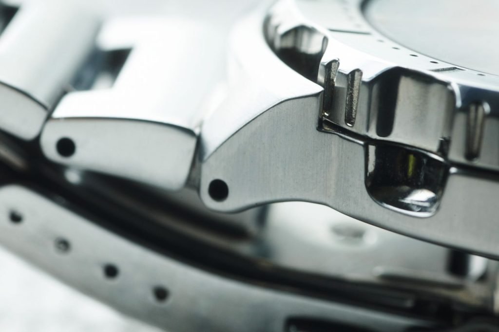 Detailed close-up of a metallic watch band showcasing modern and shiny design elements.